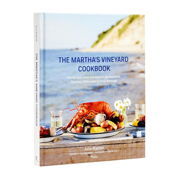 photo of a book cover with a tablescape of seafood set on the shore of Marthas Vineyard.